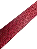 Corbata de seda azul marino con estampado paisley en tonos rosados y blancos.