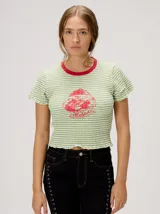 Remera baby-tee a rayas verde y blanca con cuello redondo rojo y gráfico impreso en la parte delantera, de manga corta y textura fruncida.