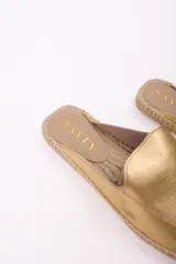 Zueco de cuero color chocolate con detalle de costuras rojas en la suela de yute.