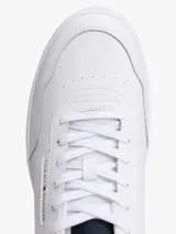 Zapatillas de estilo retro baloncesto Tommy Hilfiger, de corte bajo, confeccionadas en piel y poliuretano. Presentan un diseño en color blanco con paneles en contraste en color granate y azul marino en el talón. Cuentan con suela gruesa de goma, detalle de ventilación en la parte superior y logo de la marca en el lateral y la lengüeta.