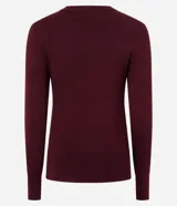 Suéter de punto ajustado color crema, con cuello redondo, manga larga y detalle de botones metalizados en los puños.