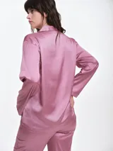 Camisa de dormir de satén con cuello solapa, cierre frontal con botones y mangas largas. Presenta un corte holgado y fluido.