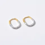 Aros tipo argolla ovalados, con mitad superior dorada y mitad inferior plateada.