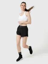 Short deportivo 2 en 1 de color negro, confeccionado en tejido técnico transpirable. Presenta una cintura elástica ancha con detalle de líneas blancas y logo, short interior ajustado para mayor sujeción y bolsillos laterales invisibles.