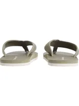 Ojotas de hombre color verde oliva, con suela de EVA texturizada y tiras de lona con monograma CK.