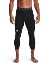 Calza de compresión deportiva Under Armour modelo HeatGear, de largo 3/4, color negro. Presenta cintura elástica ancha con logo de la marca y bolsillo lateral Strength Pocket.