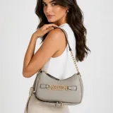 Cartera Guess modelo Celestia, de color gris, confeccionada en material sintético con textura geométrica en relieve y logo de la marca estampado. Cuenta con cierre superior, herrajes dorados, detalle de hebilla con el nombre de la marca al frente y correa ajustable para llevar al hombro o cruzada.