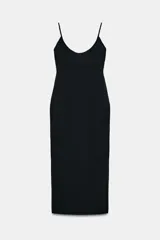 Vestido midi negro, entallado, con escote redondo y tirantes finos ajustables. Presenta costuras verticales marcadas en el frente y un detalle de fornitura a tono en el escote.