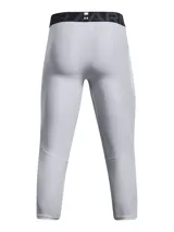Calza deportiva de compresión tipo 3/4, color gris claro, con cintura elástica ancha negra con logo de la marca. Presenta paneles de malla para ventilación, bolsillo lateral y logo de Under Armour en la pierna.