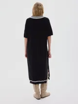 Vestido midi tejido color rojo, con cuello camisero azul marino y rayas blancas, escote en V con tres botones, manga corta con detalle de raya azul marino y aberturas laterales en el ruedo.