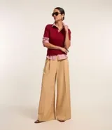 Pantalón de mujer estilo pantalona de sastrería color beige, con pliegues delanteros y cintura sencilla con botón.