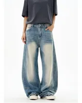 Jean de denim azul claro con efecto lavado y amplios paneles deslavados en la parte delantera de los muslos. Presenta un corte extremadamente ancho y holgado (baggy), con puños ajustados en los tobillos.