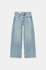 Jeans de tiro medio y corte wide leg, de cinco bolsillos, en denim de lavado claro. Cuenta con cierre frontal de cremallera y botón metálico.