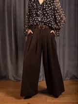 Pantalon tipo palazzo de corte amplio y tiro alto, con pinzas frontales, bolsillos laterales y cintura elástica.