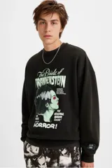 Buzo de cuello redondo en color negro, con estampado gráfico frontal de The Bride of Frankenstein. Presenta un corte holgado y puños acanalados.