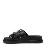 Sandalias slide de mujer Miss Carol modelo Nami, color negro con tiras cruzadas y tachas metálicas plateadas. Cuenta con suela plana con plataforma y diseño cómodo para uso diario.