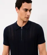 Polo de punto azul marino para hombre, confeccionada en algodón con textura de rayas verticales y patrón en zigzag, cuello polo con cierre frontal parcial y mangas cortas.