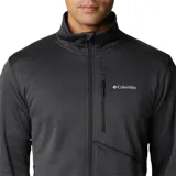 Campera de polar Columbia color gris oscuro, con cierre frontal completo, cuello alto, bolsillos laterales con cierre y bolsillo vertical con cierre en el pecho. Logo de la marca bordado en el pecho.
