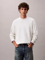 Sweater de punto técnico con corte boxy y cuello semi alto. Presenta un diseño minimalista de manga larga con puños en contraste y ajuste relajado.