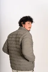 Campera puffer verde militar, de cuello alto, con cierre frontal y bolsillos laterales.