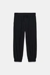 Pantalón tipo jogger de tiro medio, con cintura elástica ajustable mediante cordones, bolsillos frontales y puños elásticos en el bajo.