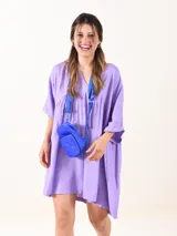 Vestido corto color lavanda, de corte suelto, con escote en V y mangas 3/4.