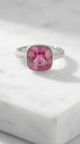 Anillo de plata con cristal cuadrado fucsia facetado y engaste con circonias en la banda.