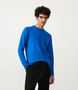 Suéter de punto fino con cuello redondo y manga larga, de corte slim y diseño liso.