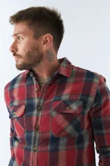 Sobrecamisa de viyela a cuadros rojos y azules con interior capitoneado, corte regular, manga larga, cierre con botones, bolsillos frontales y logo en grifa de cuero.