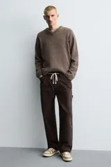 Zapatillas deportivas de caña baja color beige, con cordones y suela gruesa.