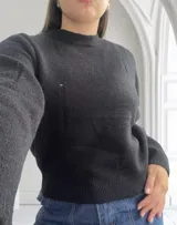 Sweater negro de lana con cuello redondo y mangas largas.