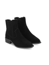 Botin chelsea de inspiración tejana de cuero gamuza color negro, con elásticos recubiertos, taco bajo cuadrado y punta fina.