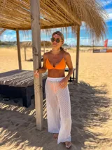 Conjunto de bikini naranja, con corpiño triangular fijo y bombacha vedetina regulable.