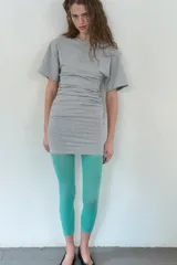 Vestido corto de algodón color negro, con cuello redondo, mangas cortas amplias y detalle de frunces elásticos laterales.