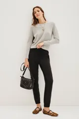 Pantalon tipo babucha de gabardina elastizada color negro, con cintura elástica ajustable mediante cordón y puños en los tobillos. Presenta bolsillos diagonales en el frente y bolsillos traseros con solapa y botón.
