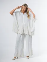 Maxi camisa color blanco de lino bordado con manga abullonada y calce amplio.