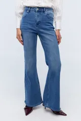 Jean acampanado de tiro medio, color azul denim, con detalle de flor bordada en el bolsillo trasero.