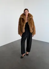 Pantalón de tiro alto con diseño balloon, confeccionado en mezcla de lana, con cierre de cremallera lateral y forro interior.