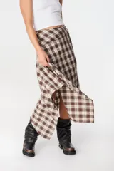 Falda midi de corte asimétrico con diseño de rayas horizontales en blanco y negro. Confeccionada en tejido satinado con caída fluida.