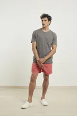 Remera gris con bolsillo ojal en el pecho, de manga corta y cuello redondo.