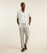 Pantalón masculino de corte relajado confeccionado en tejido oxford de algodón. Presenta cintura con trabillas y cordón ajustable, bolsillos laterales y bolsillos traseros.