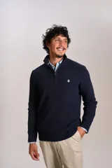 Sweater de punto acanalado color azul marino, con cuello alto y cierre frontal parcial. Presenta el logo de la marca bordado en el pecho y puños con terminación elástica.