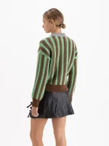 Sweater de punto con diseño de ochos y rayas verticales en color rojo. Presenta cuello redondo, puños y cintura en contraste de color marrón oscuro.