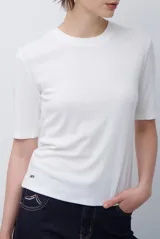 Remera básica de algodón color blanco, con cuello redondo y mangas que llegan hasta el codo.