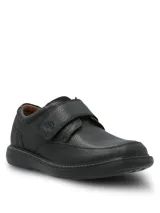 Zapato de cuero negro con textura granulada, diseño de punta redonda, suela de goma EVA y cierre de velcro con tira ancha.