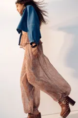 Pantalón globo rosado con estampado paisley, cintura elástica y bajos ajustados con elástico.
