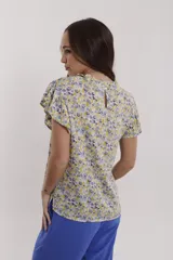 Blusa coral con mangas cortas con volados y cuello redondo con detalle de volados.