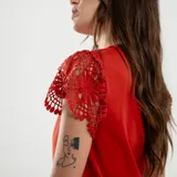 Blusa roja con escote en V y mangas cortas con detalle de encaje.