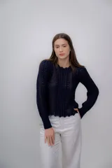 Sweater azul marino de punto calado, confeccionado en 100% baby alpaca, de manga larga y cuello redondo.