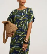 Vestido midi de corte recto, confeccionado en viscolycra con estampa de follaje en tonos verdes, azules y blancos. Presenta cuello redondo, mangas cortas y un tajo lateral en el dobladillo.